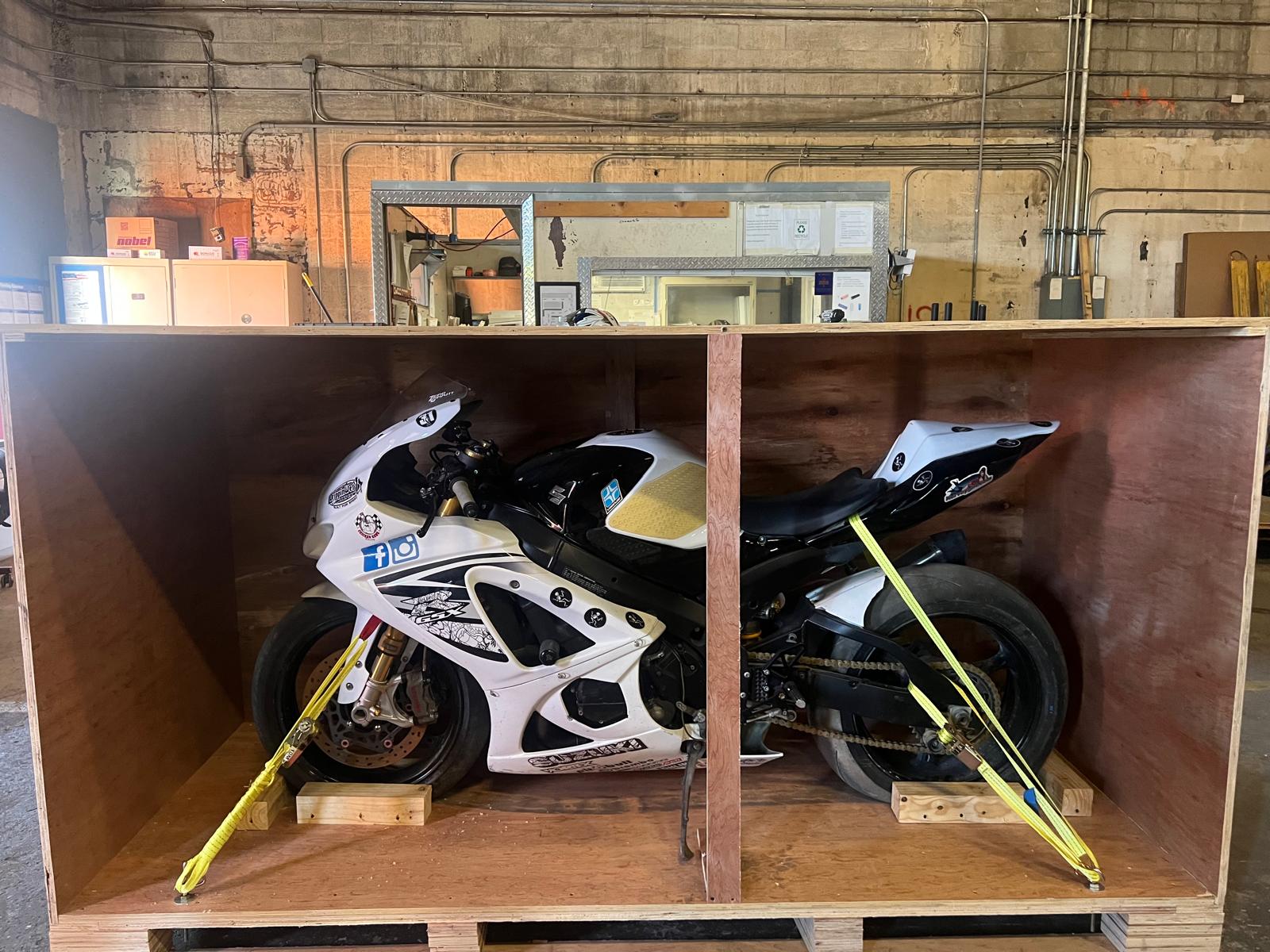 Motorcycle secured in custom crate for international shipping