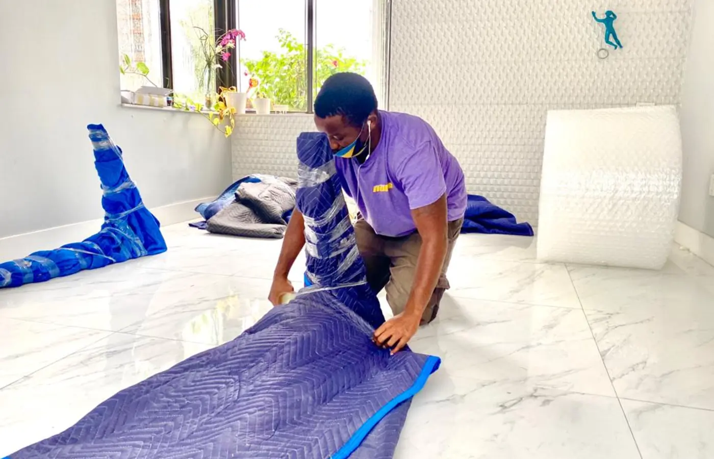 Nobel Relocation mover professionally wrapping furniture for long-distance and international relocation