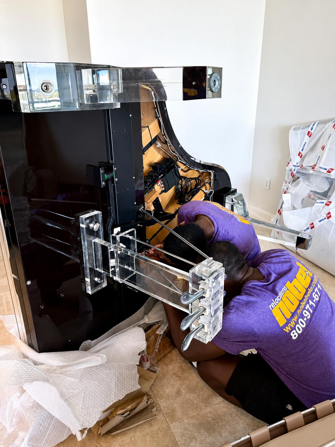 Nobel Relocation specialty piano movers preparing a piano in South Florida