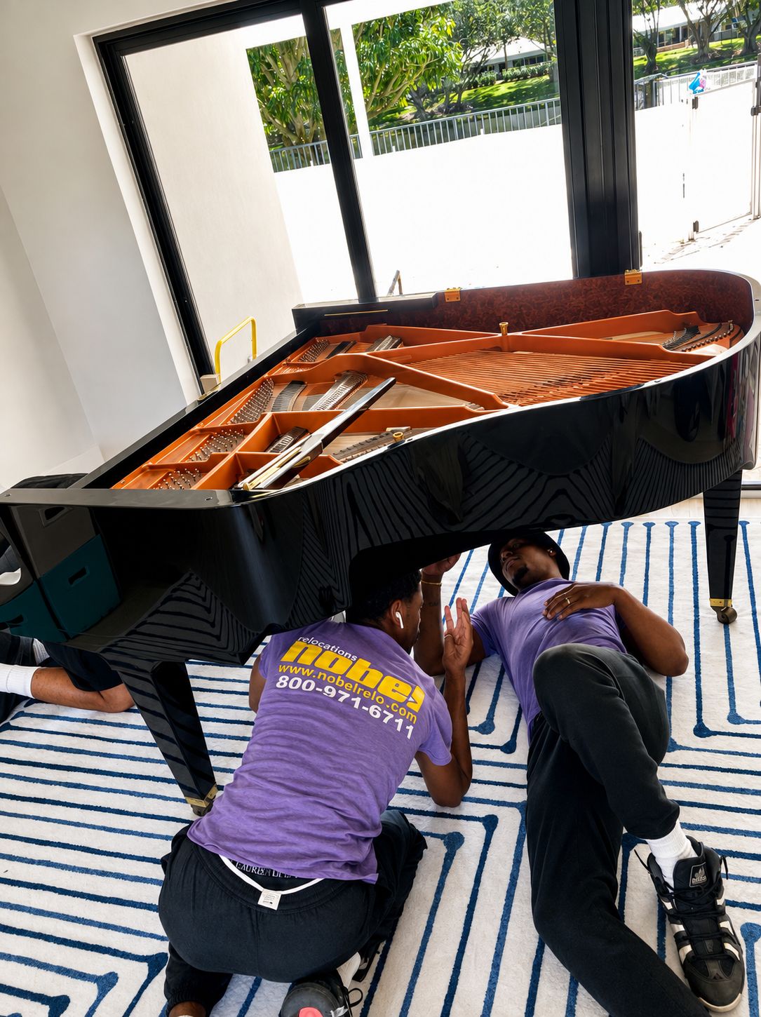 Nobel Relocation piano movers handling a grand piano in Miami