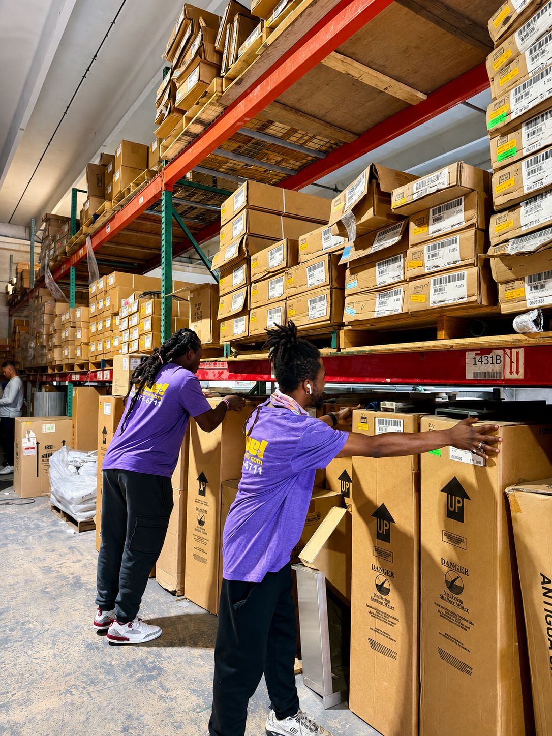 Nobel Relocation team handling household goods at the Miami storage warehouse