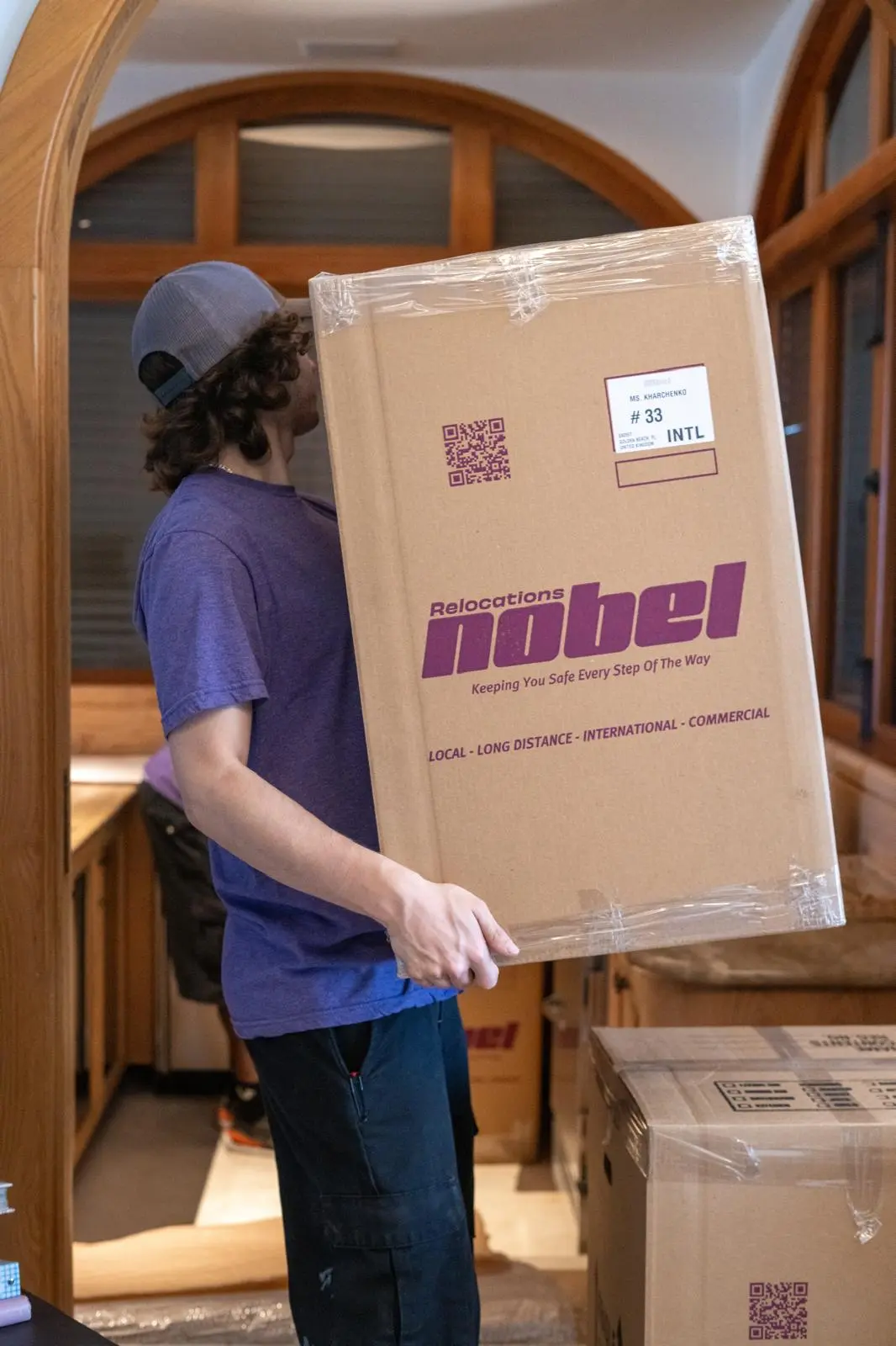 Nobel Relocation mover handling a professionally packed international moving box