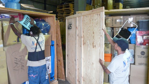 Nobel moving team professionally packing a wooden liftvan