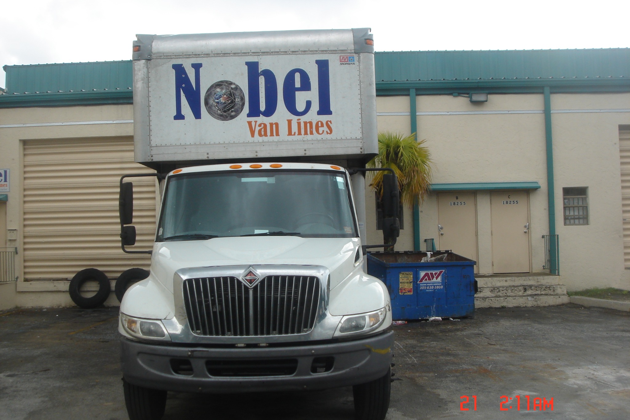 An early Nobel Van Lines moving truck outside the company warehouse