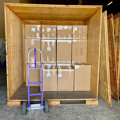 Labeled household goods stored inside a Nobel Relocation wooden vault